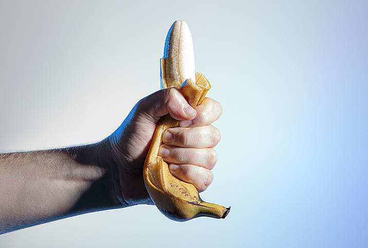 A hand demonstrating death grip syndrome on a banana.