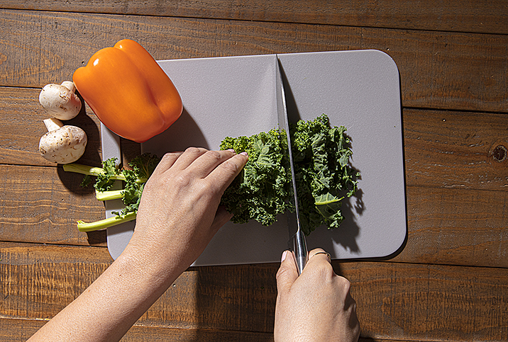 Vegetables being chopped. Monitoring you diet, avoiding certain foods and loading up on others may help many people manage herpes outbreaks. 