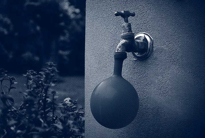 A water tap fills up a water balloon.