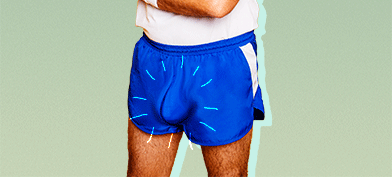 A man in workout attire with a defined bulge in their shorts.