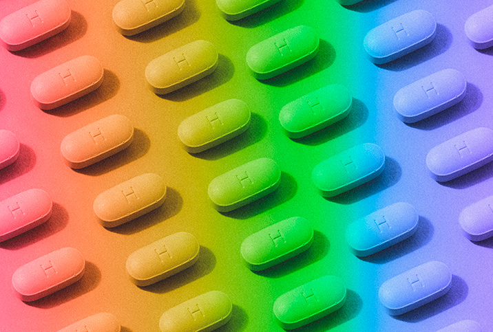 Pills are arranged in a pattern with a rainbow-colored overlay.