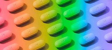 Pills are arranged in a pattern with a rainbow-colored overlay.