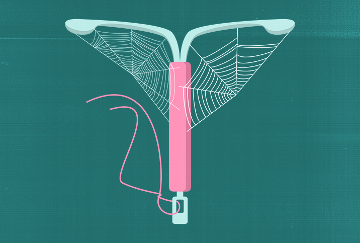 pink IUD with cobwebs on dark green background