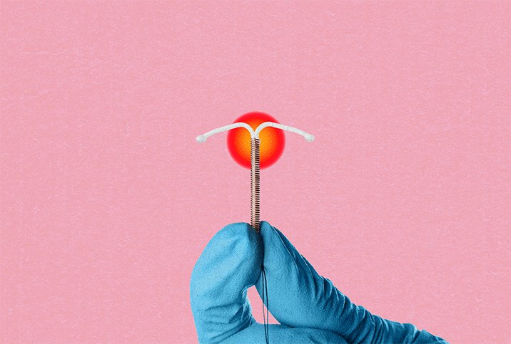 blue gloved hand holds IUD with red circle behind it on pink background