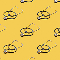 Identical stethoscope images cover a yellow background. 