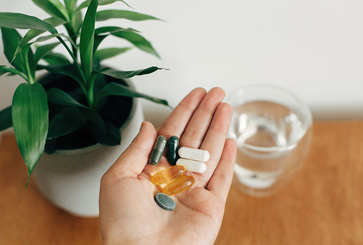 A-hand-is-holding-different-kinds-of-pills