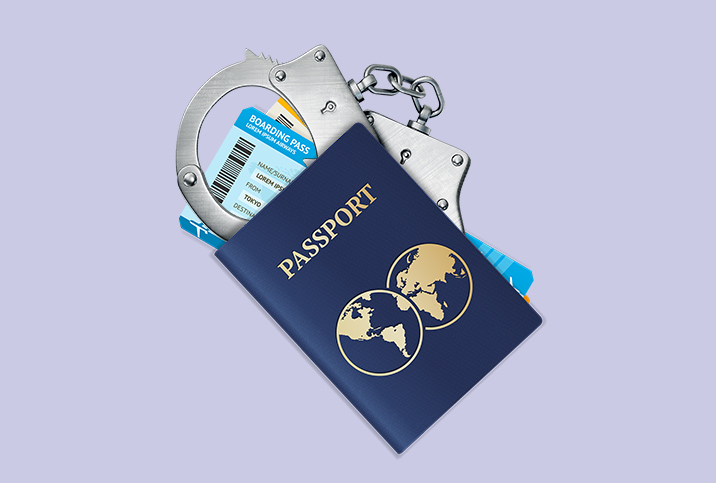 A-passport-lies-on-top-of-a-boarding-pass-and-handcuffs