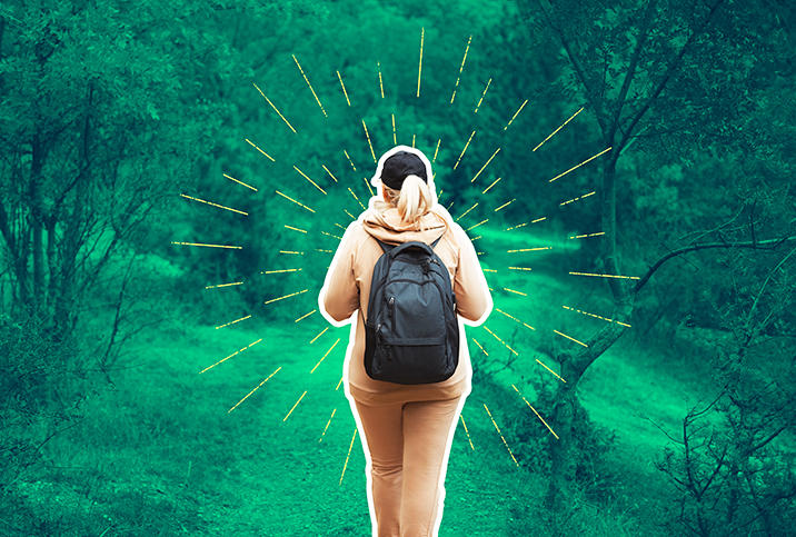 A-woman-is-walking-with-backpack-and-hat