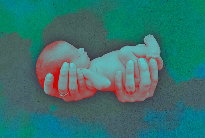 Two-hands-holding-a-premature-baby