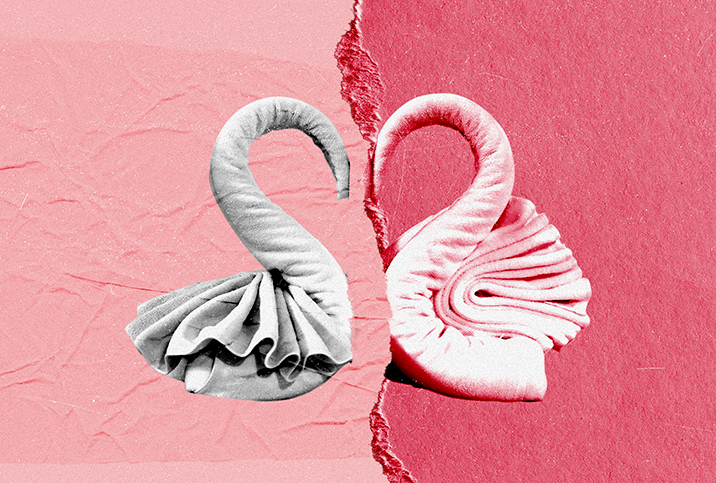 Two towels formed into half a heart break apart against a multi-shaded pink background.