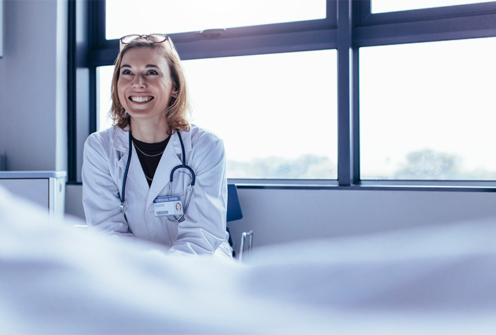 A doctor trained in trauma-informed care talks to a patient.