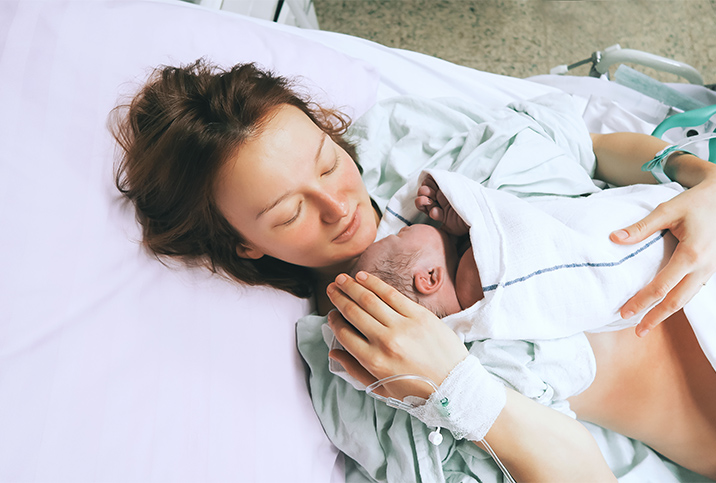 A mother holds her newborn baby after childbirth.