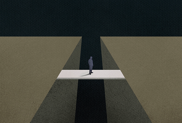 A man is crossing over a bridge to the other side.