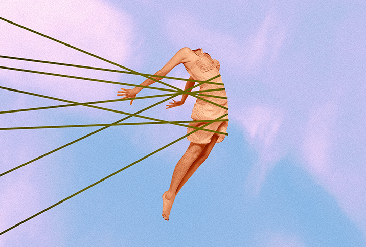 An arched, headless female body against a blue and pink sunset is held back by threads. 