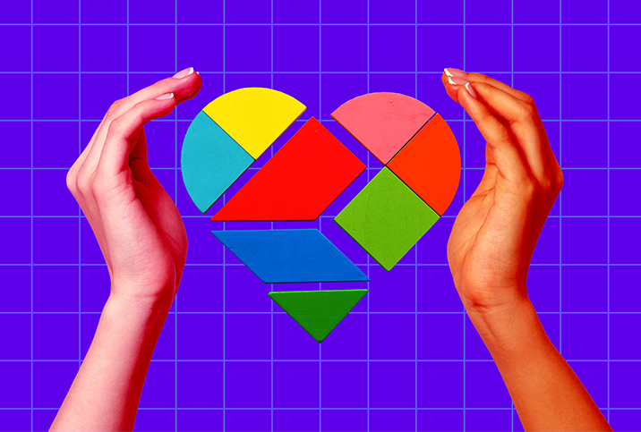 Two hands surround geometric pieces that form a heart.