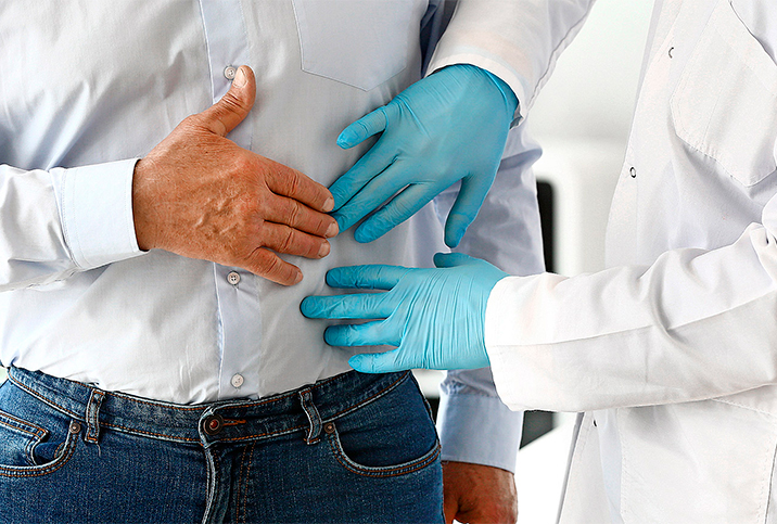 A doctor performs an exam on a male patient.