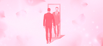 A man stands in front of a mirror with a pink cloudy background.
