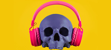 A purple skull wearing pink headphones sits on a bright yellow background.