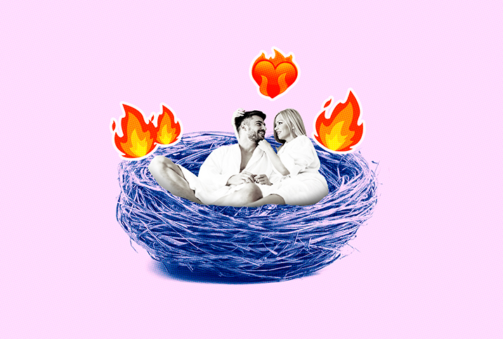 A couple cuddle in a bird's nest with fire and heart emojis floating around them.