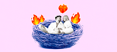 A couple cuddle in a bird's nest with fire and heart emojis floating around them.