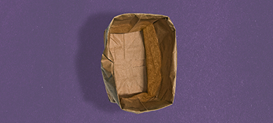 A paper bag stands open with the edges rolled down against a purple background.