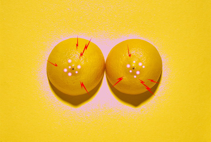 Two lemons, with their pointed sides up, have pink dots and red lightning around the centers.