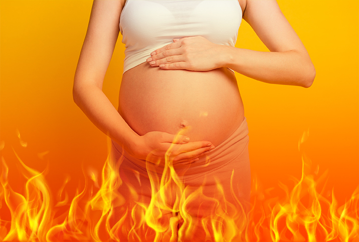 A pregnant woman holds her belly against an orange background with fire flames below.