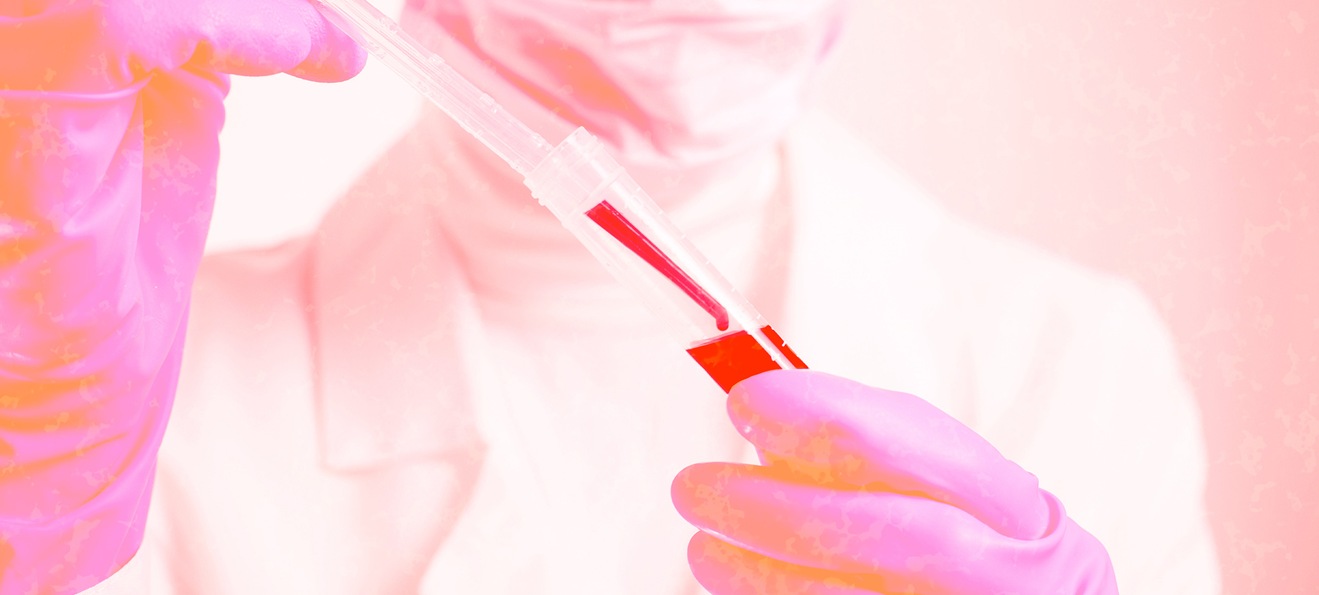 A clear dropper is adding blood to a clear plastic test tube.