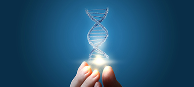A DNA strand is lit up and held by a hand at the fingertips against a blue background.