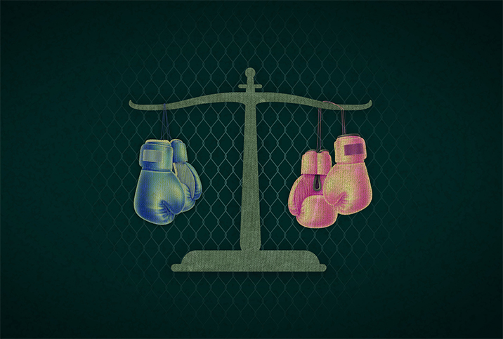 A double pan scale has blue boxing gloves hanging on the left and pink on the right.