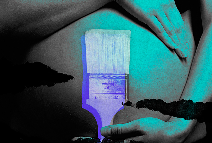 A pregnant person wraps their arms around the top and bottom of their baby bump, and a purple paintbrush lays over the belly.
