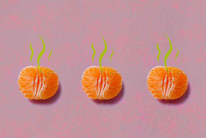Three unpeeled tangerine halves lay in a row against a pink surface with green smell lines coming from the top.