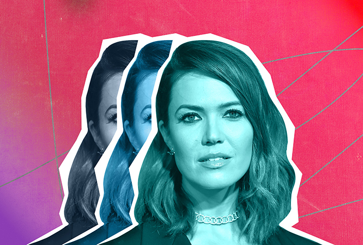 Mandy Moore's face is repeated three times, one stacking on the other, all in front of a red and purple background.