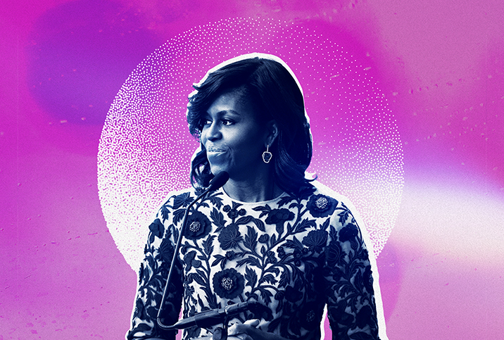 Michelle Obama stands in front of a microphone looking to her right with a fuchsia and white background.