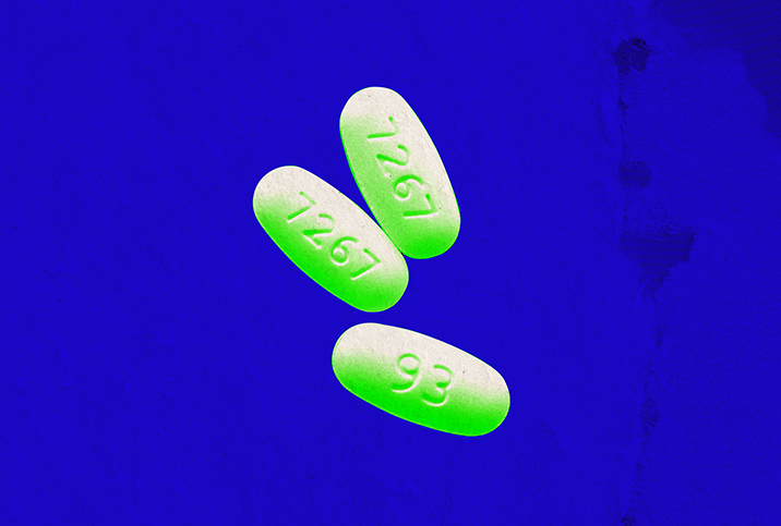 Three green and white pills are set on a bright blue background.