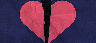 A blue paper with a pink heart is torn in half.