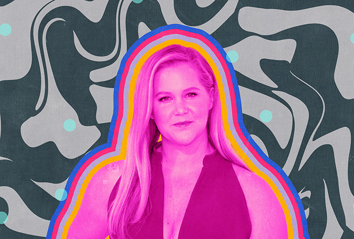 A pink image of Amy Schumer is layered on a swirled background of grey and black.