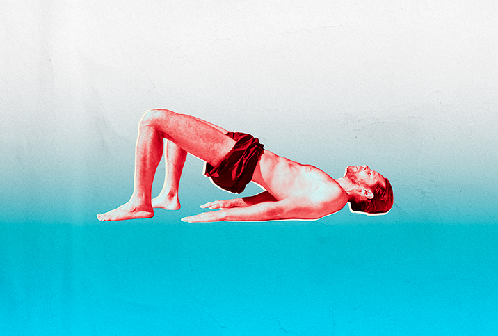 A man does bridge pose on a blue, gradient background.