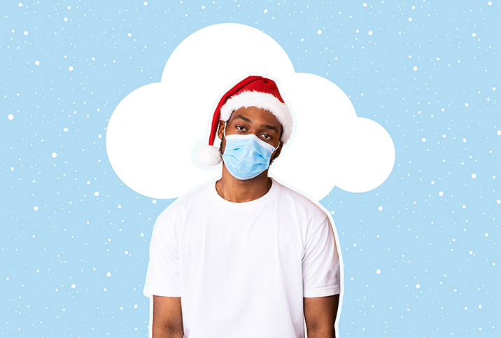 A white cloud is behind a man with a santa hat and a mask as his head tilts to the left.