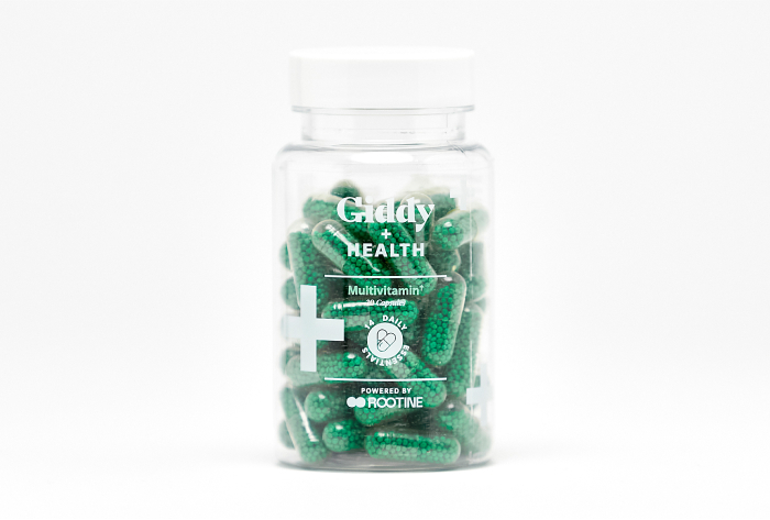 A bottle of green multivitamin for men pills.