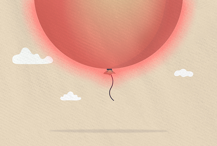 The bottom half of an enormous red balloon shows at the top of the image as it floats upward.