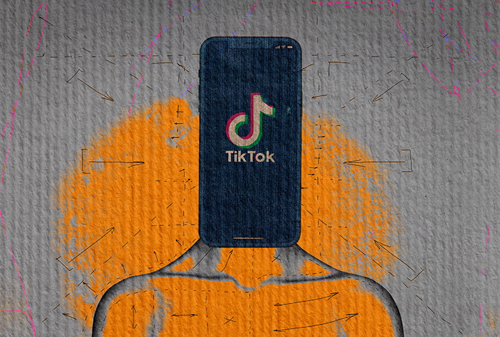 A cellphone shows the TikTok app as it sits on a body in place of a head.