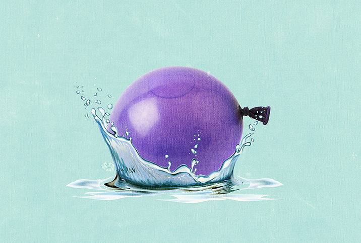 A purple balloon full of liquid makes a splash as it drops into water.