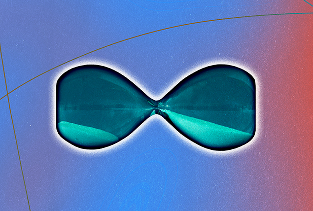 A teal-tinted hourglass lies horizontally with sand resting in both sides.