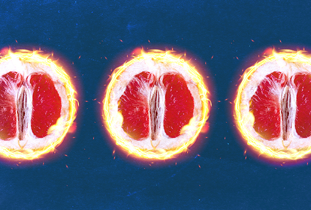 The edges of three open grapefruit halves are in flames against a blue background.