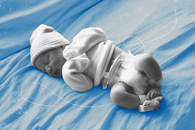 A greyscale newborn lays against a blue blanket.