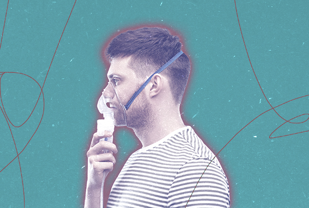 A man holds a mask to his face for breathing.