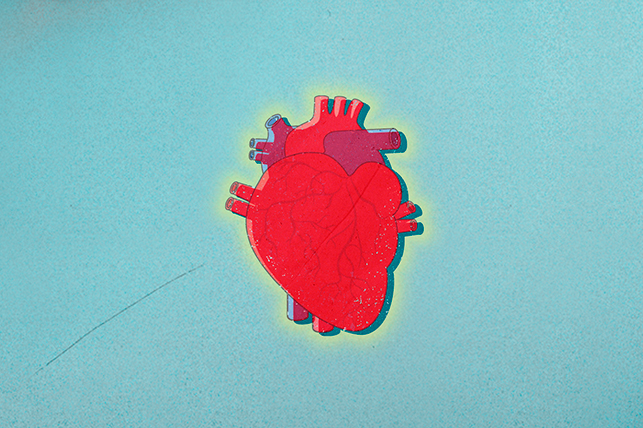 A red heart sits in the middle of a light teal background.