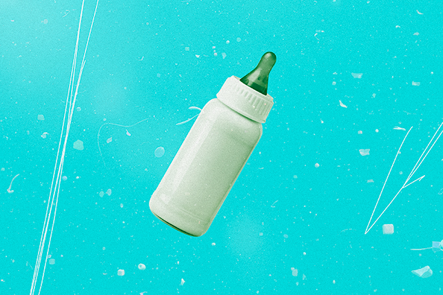 A bottle of breast milk with a green nipple is against a teal background.