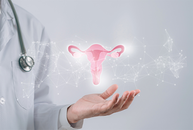 A pink glowing female reproductive system is floating over the open palm of a doctor.
